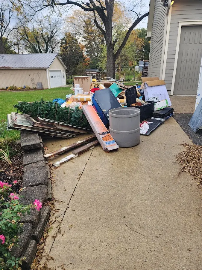 Dumpster being loaded with debris for Estate Cleanout Dumpster Rental in St. Albans